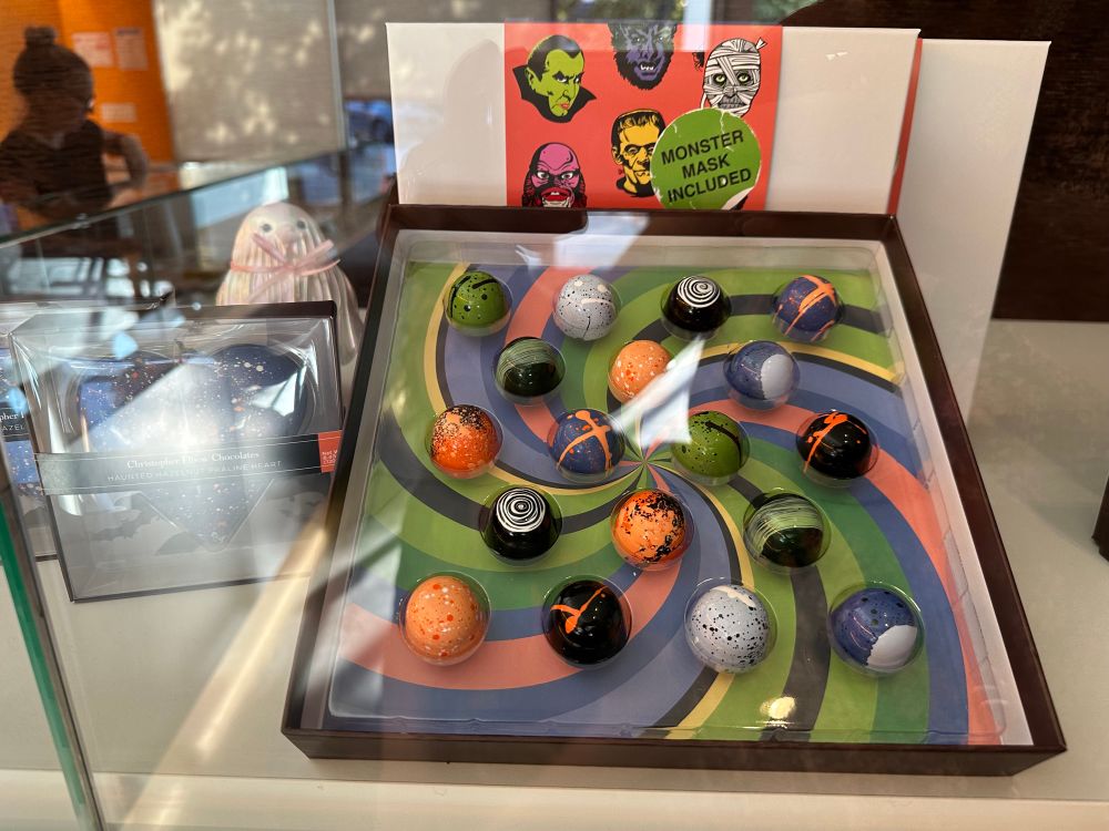 Box of 18 chocolate truffles in halloween colors like pumpkin orange and zombie green, but, like artsy. 