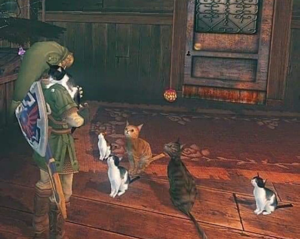 Link from Legend of Zelda: Twilight Princess, cuddles a cat, while other kitties watch on. 