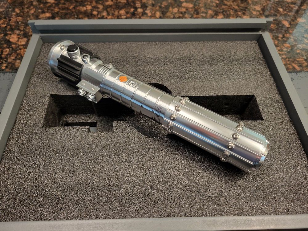 Metal lightsaber on top of black foam insert