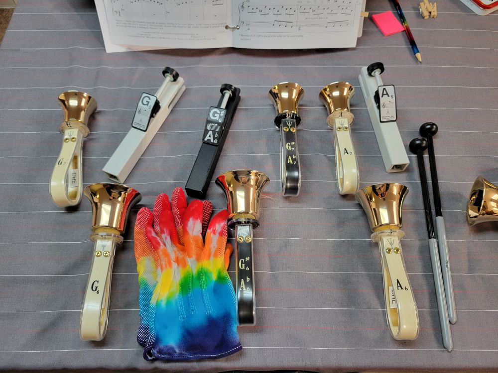 Treble handbells and chimes with a pair of rainbow gloves