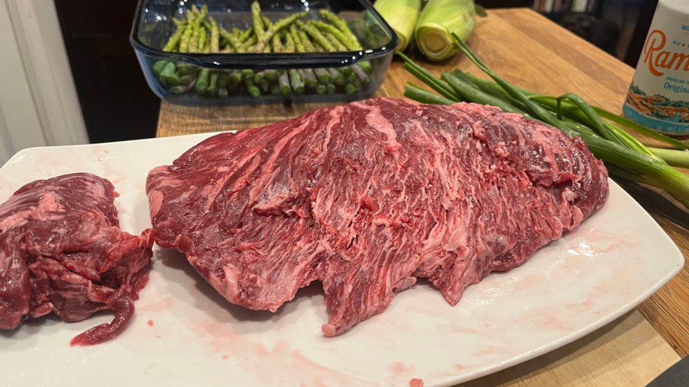 A whole well marbled Wagyu Bavette on a white plate