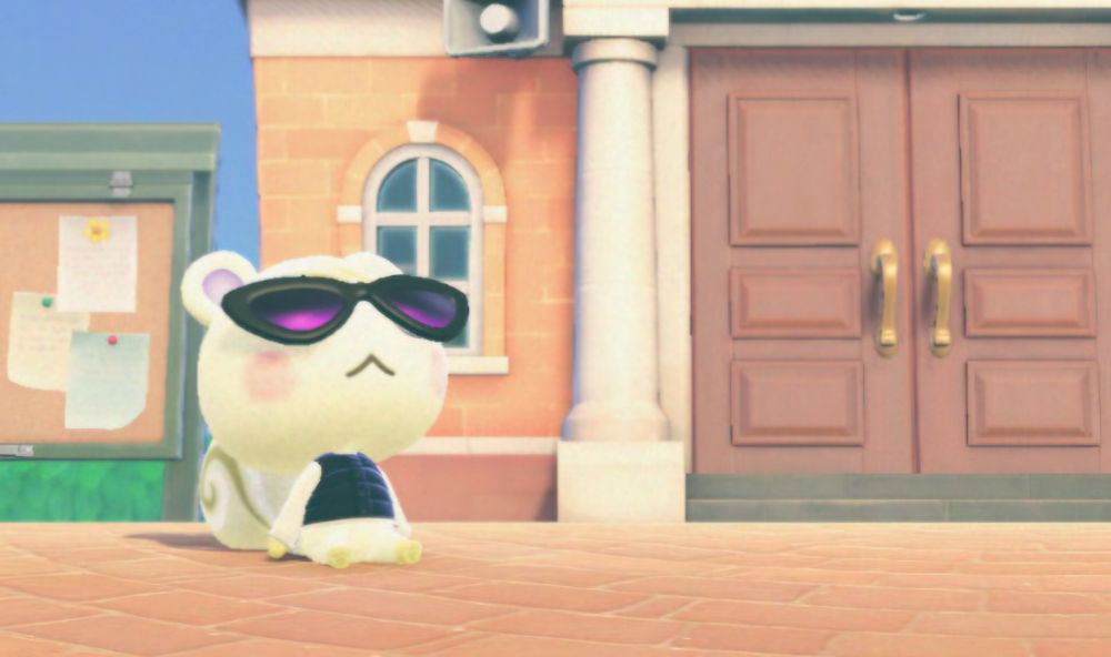 Marshall from animal crossing New Horizons is sitting on the ground in the plaza, sunbaking with sunglasses on.