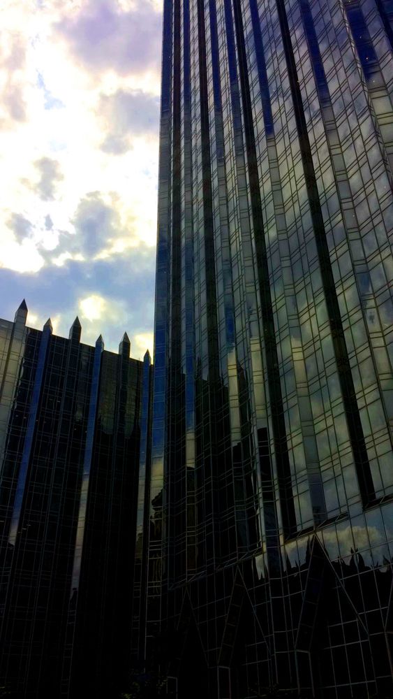 An angled view of the PPG Place building in Pittsburgh, PA on a sunny but cloudy day.