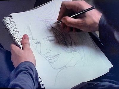 Pencil drawing of Darla (Julie Benz) Angel (David Boreanaz is creating from memory. Just hands holding a pencil and sheets of paper showing a drawing along with dark sleeves and pants. From Angel Season 2, Episode 7.
