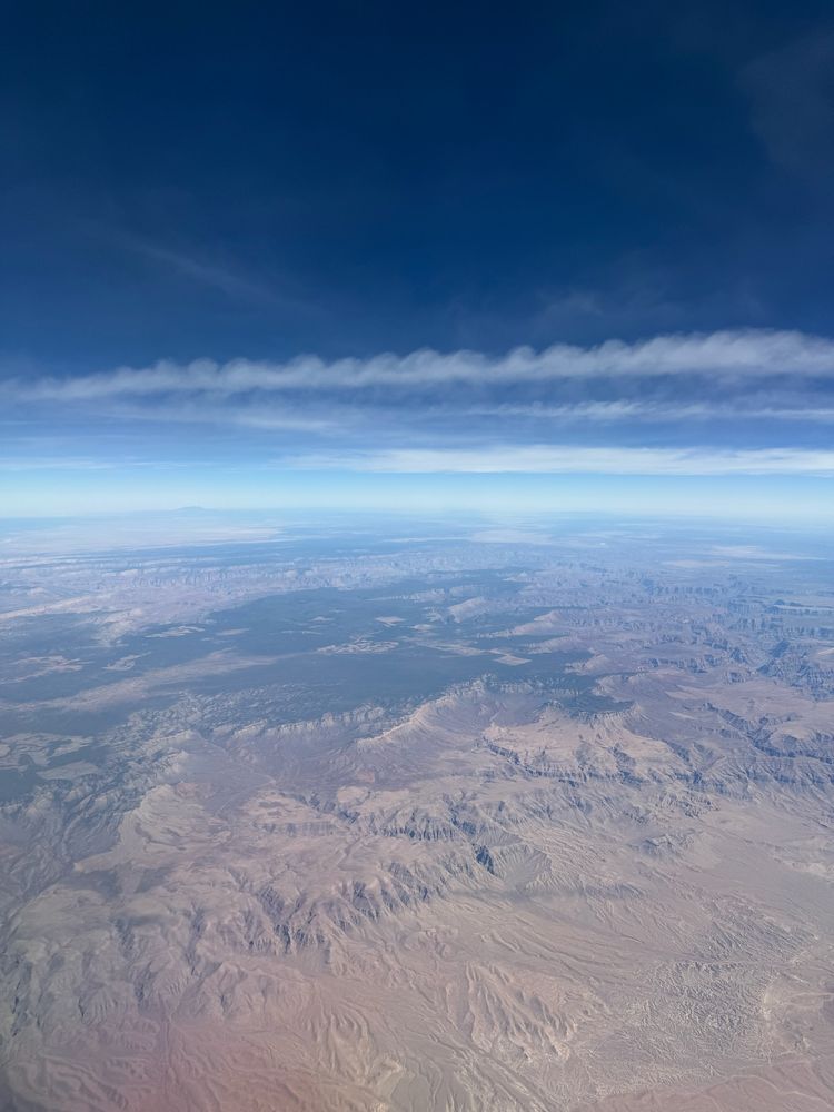 Picture taken from an airplane over the Grand canyon, at the top of the picture is a stream of clouds showing signs of a Kelvin–Helmholtz instability (a wavy pattern)