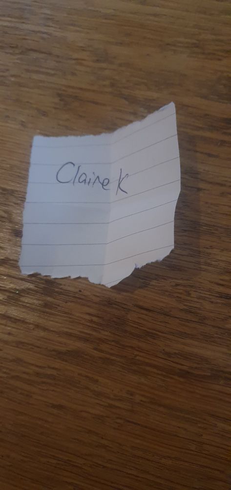 A piece of folded paper with Claire K written on it. 
