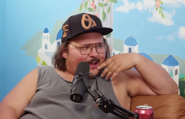 Stavros Halkias, a Greek god of a man, with a sexy little mustache and a kind of effete hand gesture, whose facial expression is surprised surprised but in a catty way