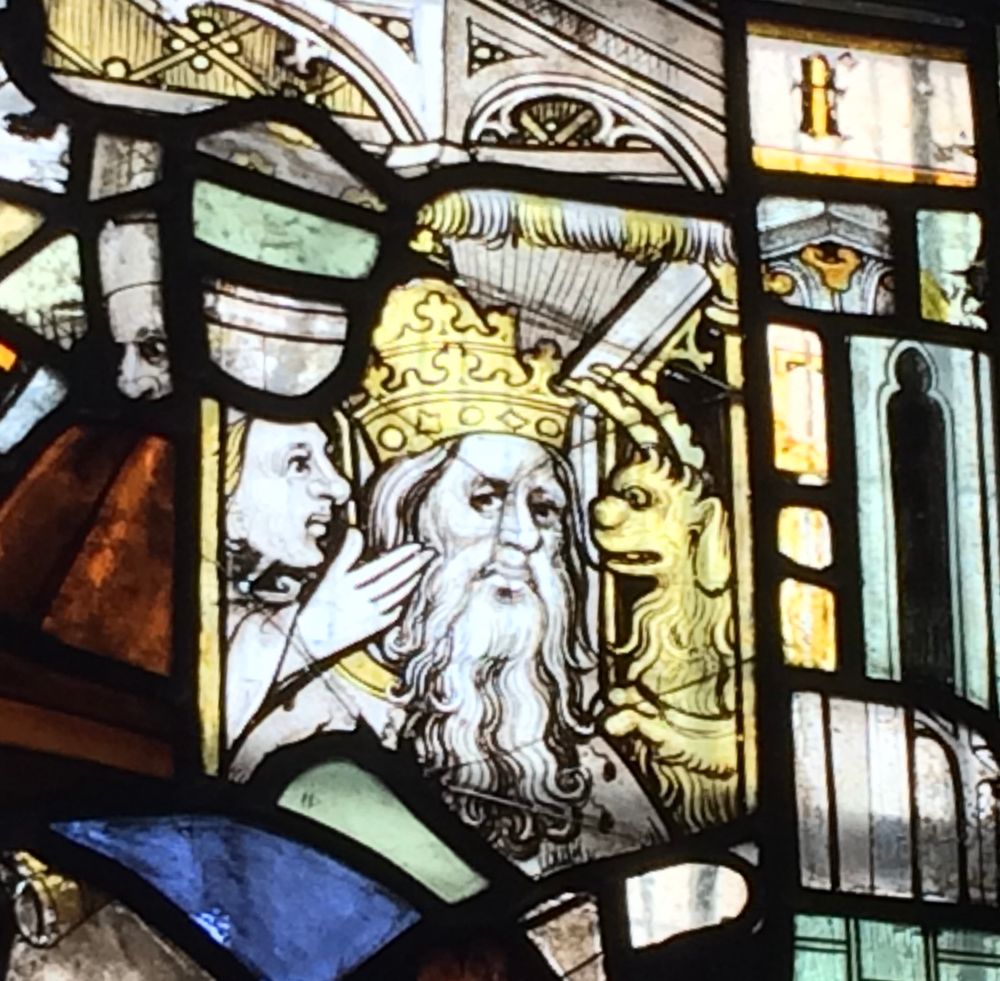 Stained glass showing Pope being tempted by the devil.