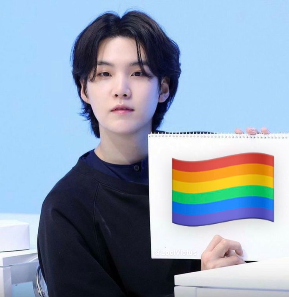 Yoongi of BTS holding up a white spiral notepad with a photoshopped price flag on it.