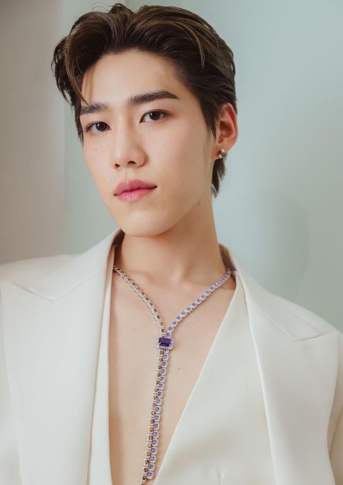 pp krit looking classically elegant in a cream blazer vest outfit. a necklace draws attention to the deep V bare chest, as if it was needed