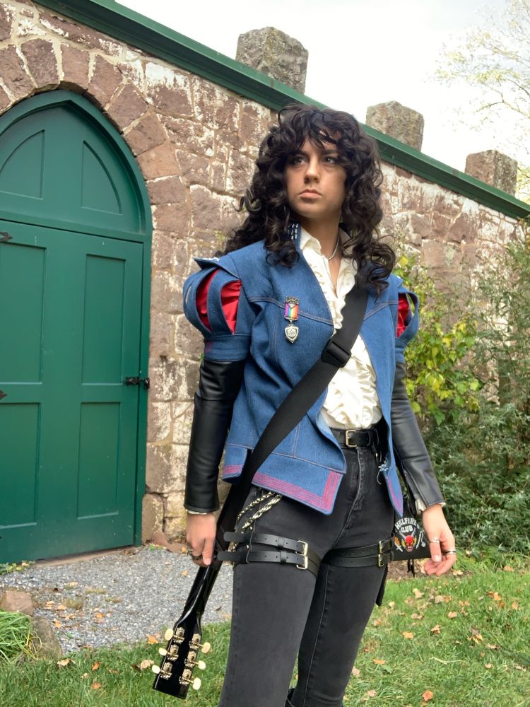 Nyx as their original design of Eddie Munson from Stranger Things but as a Bard