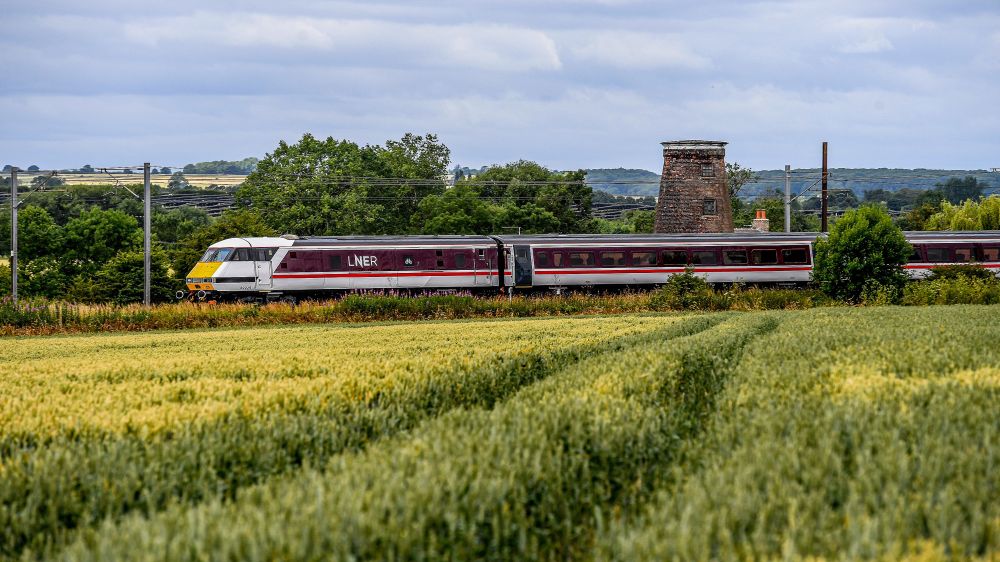 An Intercity 225 going through fields 