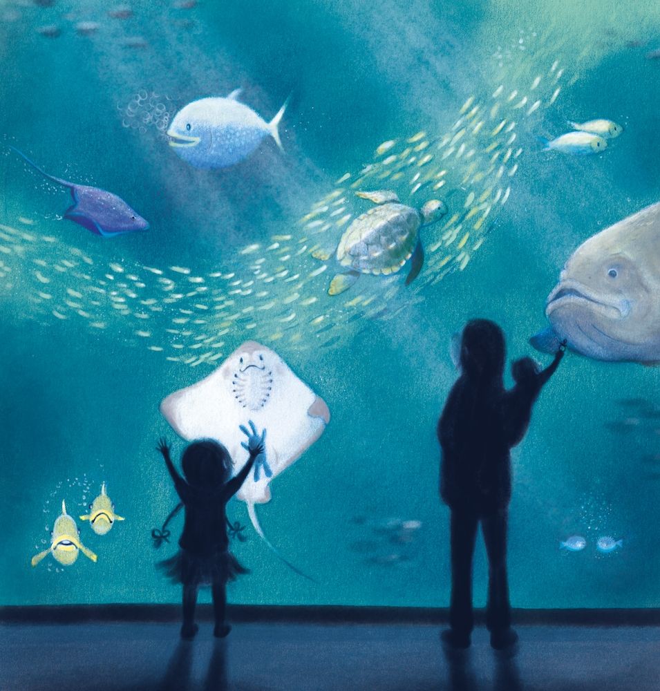 View in an aquarium. A woman carrying a baby, the baby offers her dummy to a large fish.  A girl stands palms against the aquarium glass, showing her toy bunny to a ray.