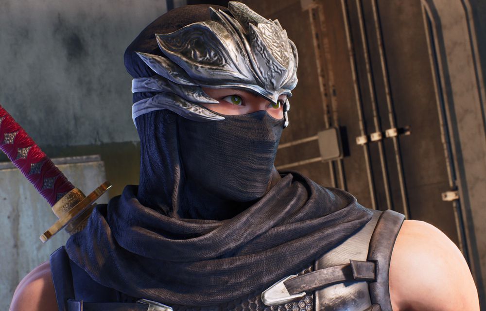 Bust-up screenshot of Ryu Hayabusa during a cutscene in Ninja Gaiden 2 Black. Ryu's head is tilted slightly away from the viewer in a 3/4 view, his eyes upturned and eyebrows raised in a light smile. The background consists of some metal pipes and concrete walls.