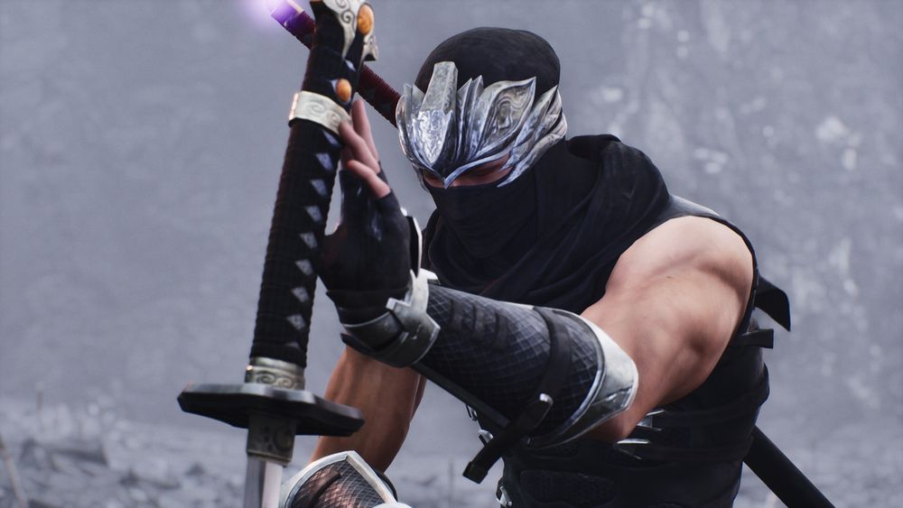 Screenshot of Ryu Hayabusa from the ending cutscene of Ninja Gaiden 2 Black. Ryu kneels down with his eyes closed, his left hand gracing the handle of the Blade of the Archfiend as he pays his respects to Genshin.