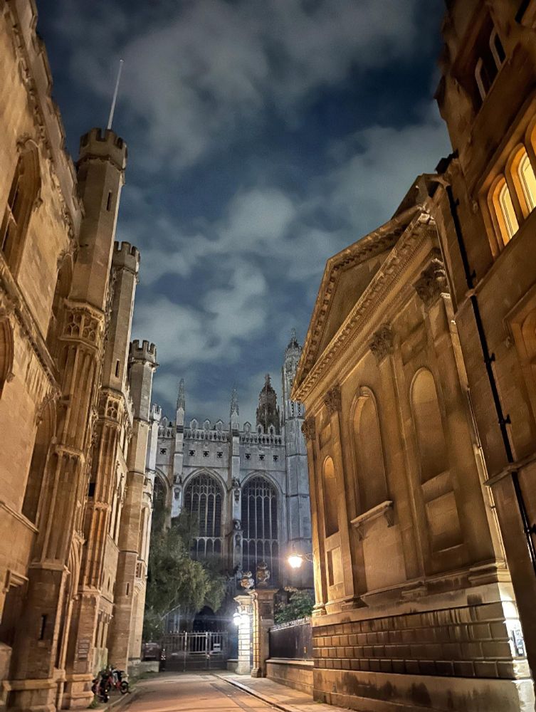 Night view of Trinity Lane flanked by historic buildings leading toward King's College Chapel in Cambridge.