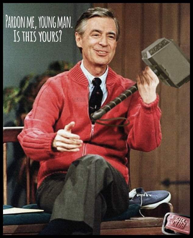 Fred Rogers, wearing his red sweater, on the set of "Mister Rogers Neighborhood." He is holding Thor's hammer. Text near his head: 

"Pardon Me, Young Man. Is This Yours?"