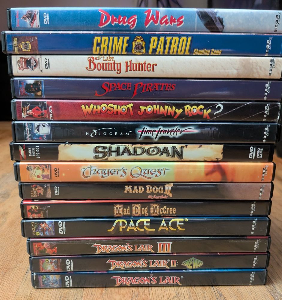 The 14 FMV DVD games I plan on playing on stream. Top to bottom: Drug Wars, Crime Patrol, The Last Bounty Hunter, Space Pirates, Who Shot Johnny Rock?, Time Traveler, Shadoan, Thayer's Quest, Mad Dog II, Mad Dog McCree, Space Ace, Dragon's Lair III, Dragon's Lair II, Dragon's Lair