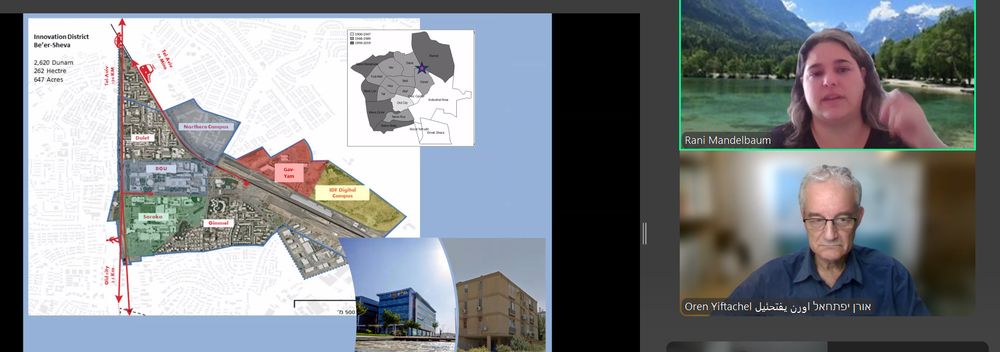 Zoom screenshot: to the right are two images of speakers at the top is Rani Mandelbaum with long hair and a dark coloured top and in the background an image of mountains and water. Below is Oren Yiftachel wearing a blue shirt and a glasses. The background is blurred. To the left is a presentation slide showing a map and buildings of Innovation District Be'er-Sheva