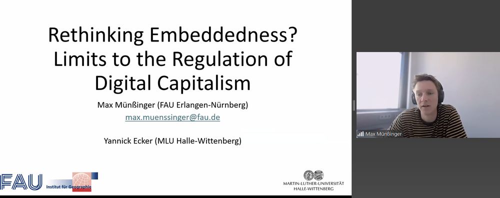Zoom screenshot: to the right is an image of Max who is wearing a striped tshirt and headphones. The background is a wall and window. To the left is a presentation slide showing the title: rethinking embeddedness? Limits to the Regulations of Digital Capitalism 
