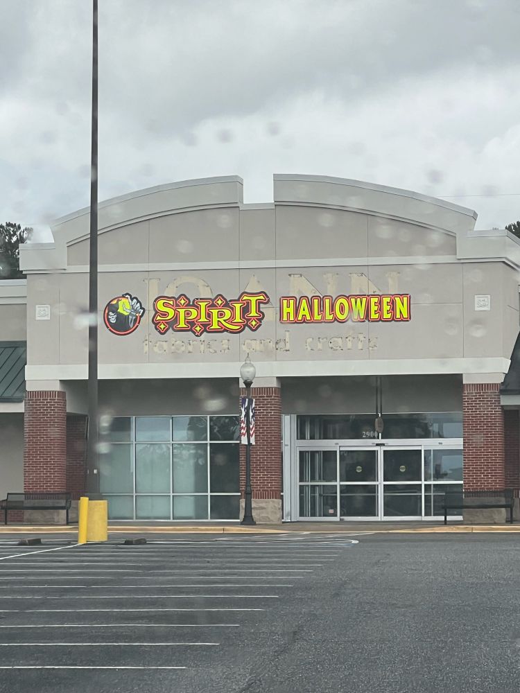 A former Joann fabrics building with a Spirit of Halloween logo rudely posted over the faded letters of the former logo. 😭