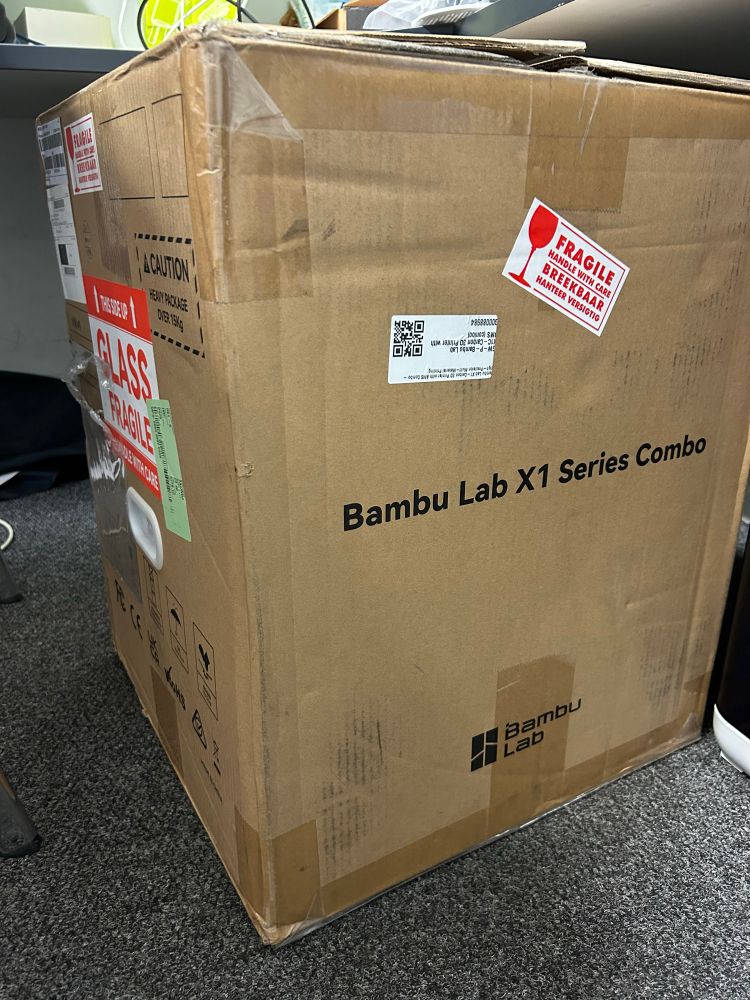 Big card board box with fragile stickers and Bambi Lab X1 Series Combo printed on the side