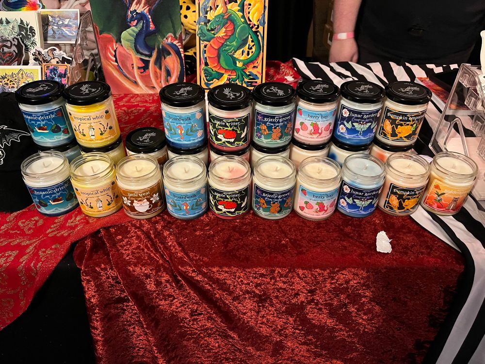 An assortment of colorful jarred candles on a circus themed table 