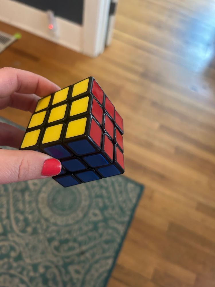 A solved Rubik’s Cube! Showing the yellow, blue, and red sides.