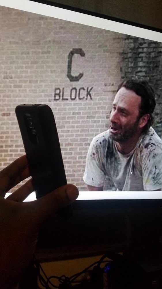 Rick Grimes looking upset at a phone