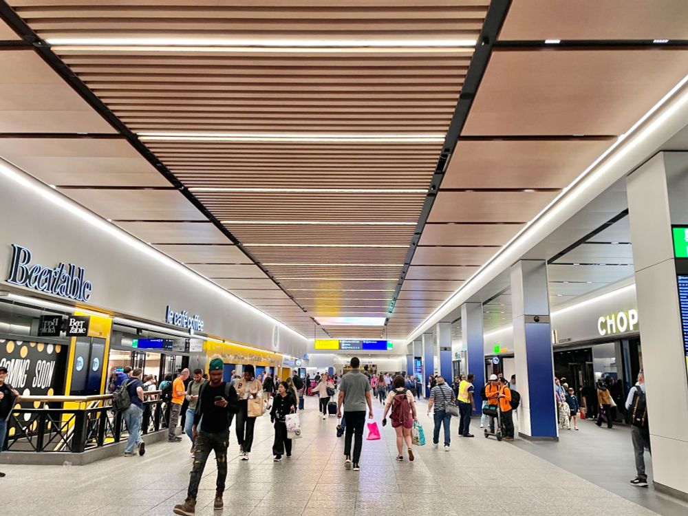 People walking through the LIRR Concourse at Penn Station.