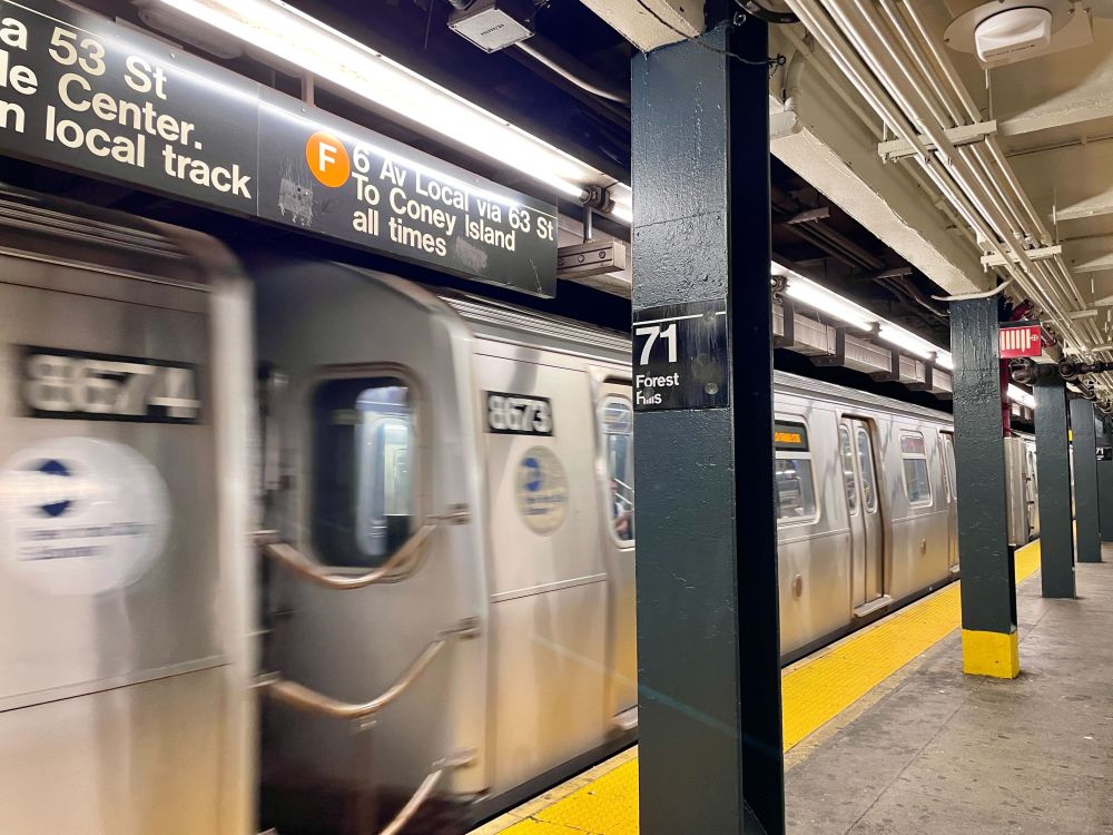 A subway train pulling into 71st Ave. Forest Hills