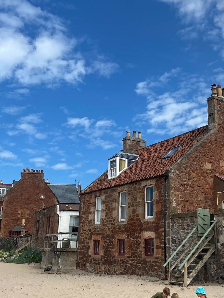 Red stone houses overlooking the beach in Crail, Scotland.