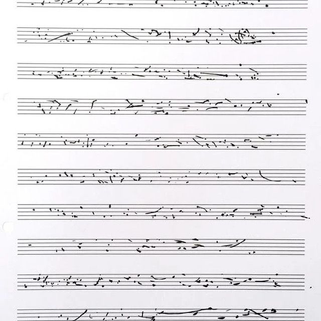 A sheet of modern graphic musical notation featuring scattered and abstract black marks, dots, and lines across traditional five-line staves. The notation appears unconventional, lacking standard musical symbols, suggesting an experimental or avant-garde composition.