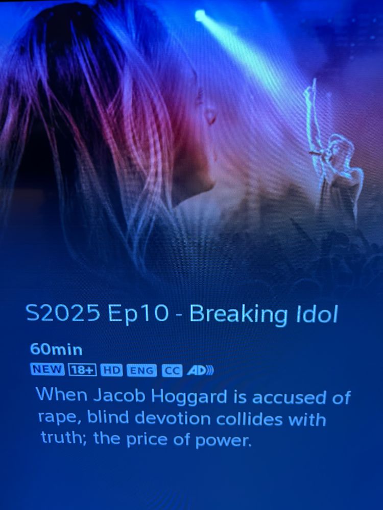 A photo of a TV screen featuring a promo for an upcoming documentary called "Breaking Idol." It's Ep 10 of the latest season of The Passionate Eye. It's 60 minutes in length and for viewers 18+. There is also an image of a singer in front of a crowd and the back of the person's head who is at the heart of this story, the survivor who took on the systems unfairly designed to protect perpetrators to secure a historic conviction.