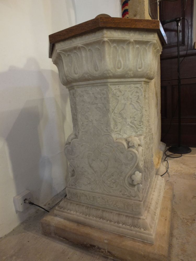 Intricately carved marble pedestal appropriated as a small font. In "Hindoo" style. Ellenborough was governor general of India 1841-4.