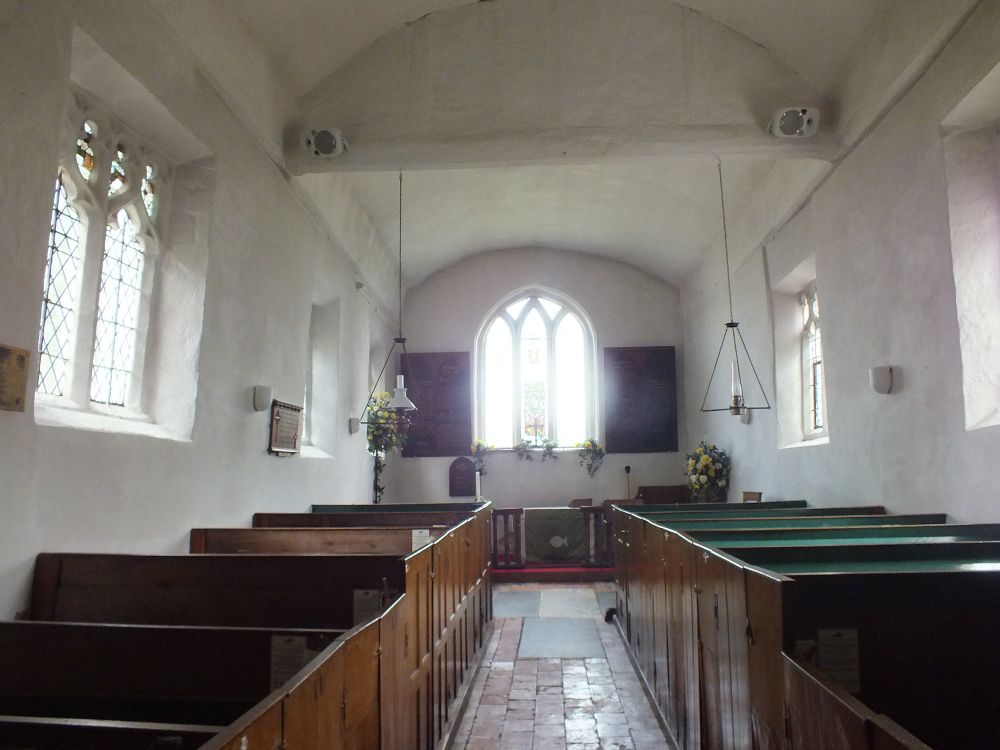 Interior looking E. Square-headed perp windows, tympanum between nave and chancel, presumably lathe-and-plaster.