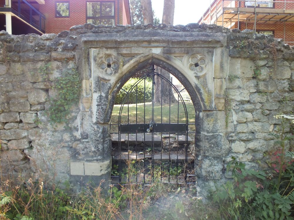 Gate from E. Pointed with encircled quatrefoils in the spandrels, R one slightly rotated.