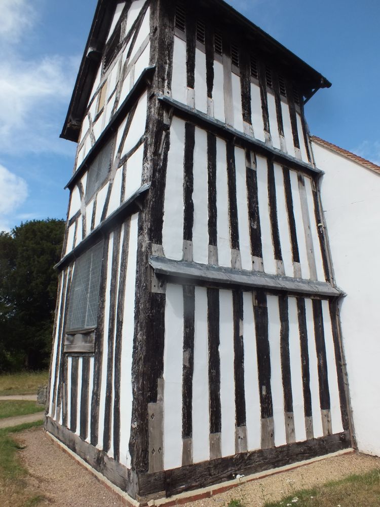 Warndon church tower from SW, showing upright studs of S side, interfacing with older (likely 12thc) nave