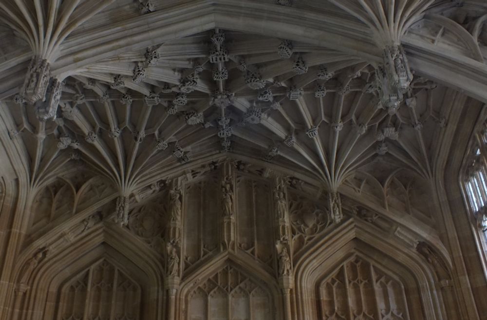 The western bay, which was the university audience during examinations. In the centre are the arms of Lionel Woodville, Chancellor of the university 1479-83. Around it are bosses with KEMP - ME - FECIT - FIERI for Thomas Kempe, Bishop of London, who gave 1000 marks (mark is 2/3 a £) to finally realise the stone vault. All the figure sculpture is original (although probably made in the 1430s)