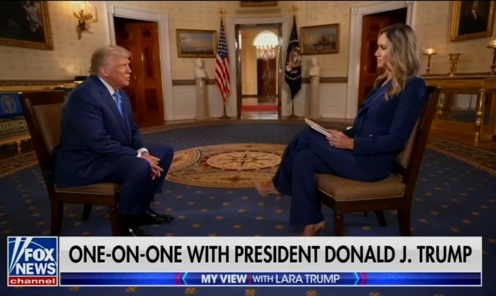 Screenshot from Fox News where Lara is Trump interviewing Donald Trump. Lara sits on a chair on the right, directly opposite Trump who's sitting on a chair on the left. There is something very weird-looking about the relative sizes of the pair. Lara looks much bigger than Trump and he looks really small as if he's a child in comparison (I mean, mentally he's a child......we all know that already)