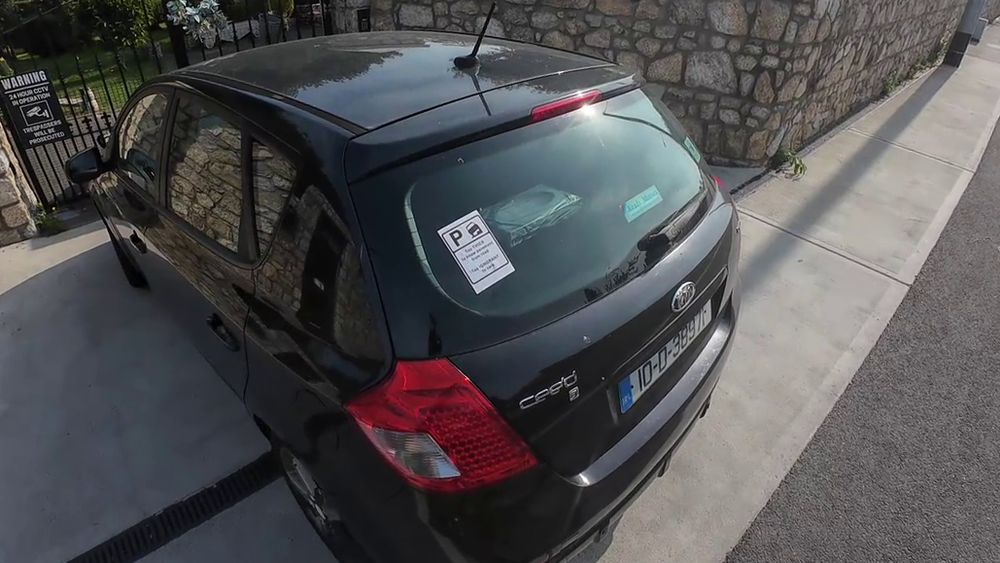 Black Nissan Micra registration 10D38971 parked across footpath on Blackglen Road, facing gated entrance to a large property, forcing pedestrians out onto cycle lane - A5 sized sticker on bottom left side of rear window reading A5 sized sticker on bottom left of driver's window reading 'Too thick to know pavement from road, too IGNORANT to care'