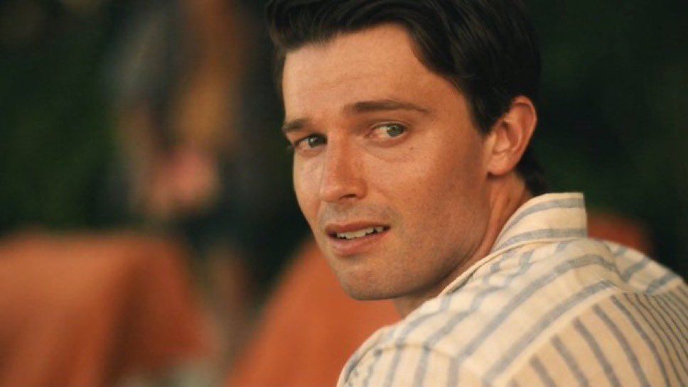 Picture of Patrick Schwarzenegger as Saxon Ratliffe in the third season of white lotus￼. He is looking over his shoulder with tears in his eyes and look of longing. ￼
