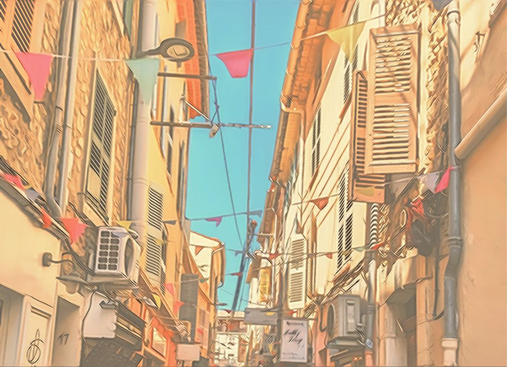 A very soft and dreamy edit of a little street in Antibes, triangular flags waving over light yellow houses with wooden blinds, heat practically radiating from the sky.