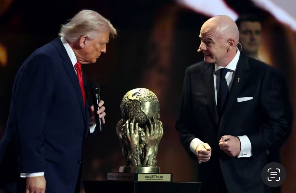 Trump staring at his phony peace trophy at World Cup Draw Ceremony.