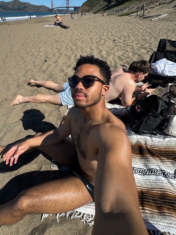 selfie on the beach with the golden gate bridge in the back 