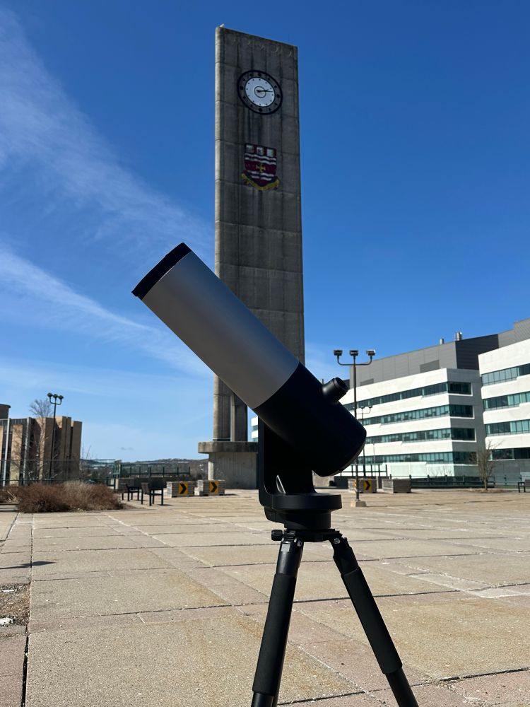 The telescope with the Memorial University clock tower in the background.