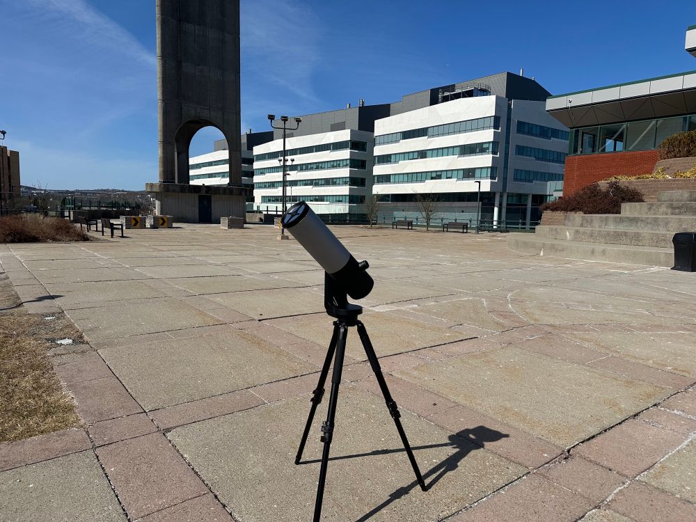 The telescope observing the Sun in front of the tower and the Core Science Facility in the background.