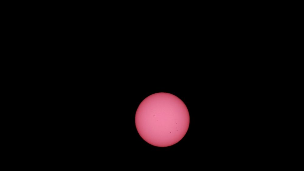 The solar disk imaged using a DWARFLAB 3 scope with some small sunspots.