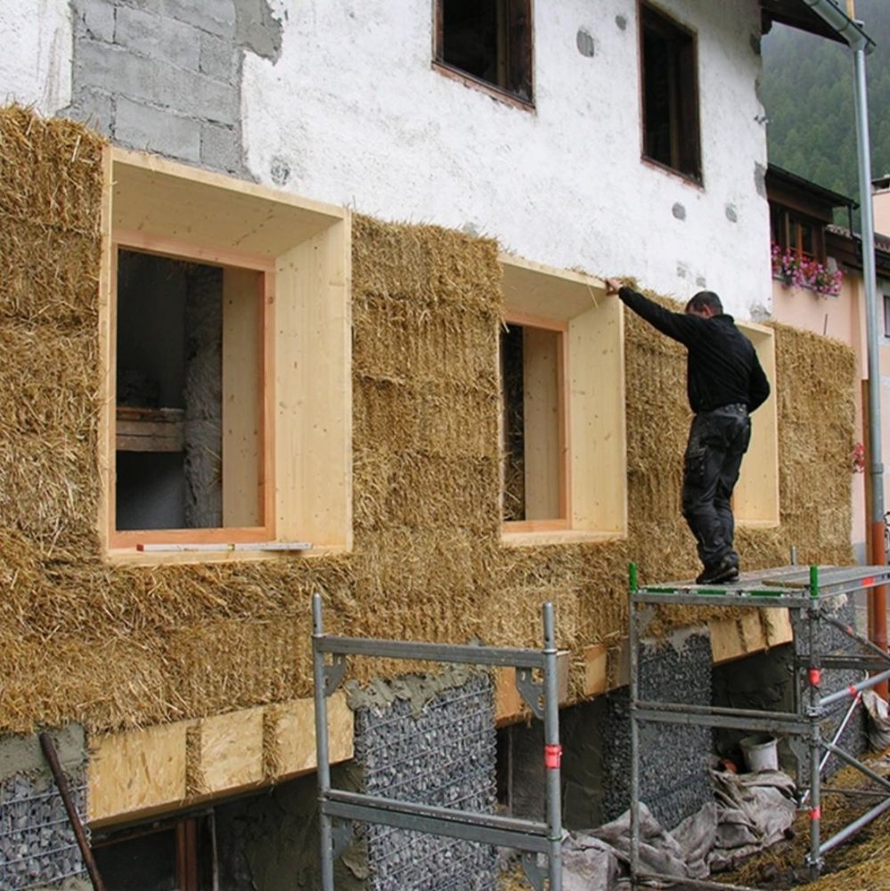 Really tight and overly thick; I guess 48cm straw bales, attached firmly on the wall,standing on a new foundatuon of gabions filled with crushed lime stone.