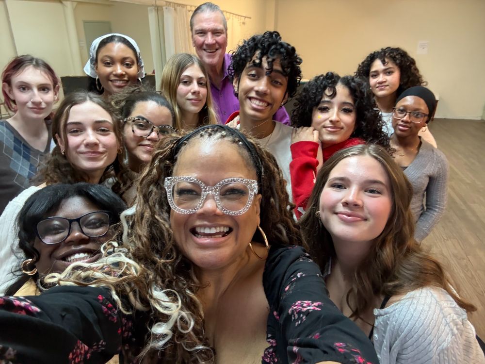 Educator & vocal artist Natalie Douglas wearing clear sparkly glasses in front, with music director Jon Weber in back, surrounded by their students (Juniors & Seniors) who took the cabaret class elective sponsored by the Mabel Mercer Foundation & the Professional Performing Arts High School in NYC in the Fall 2024-Winter 2025 semester on the last day of class.
